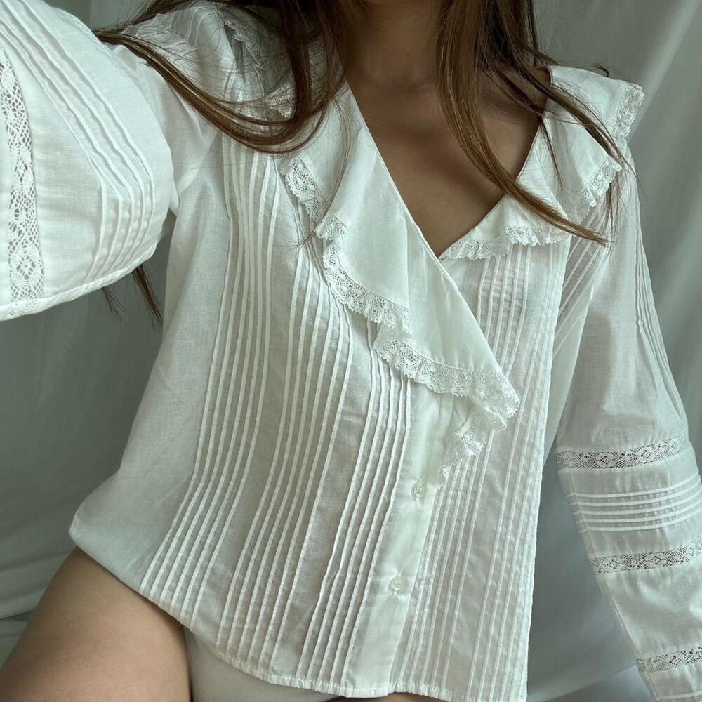 White blouse with ruffles and lace details